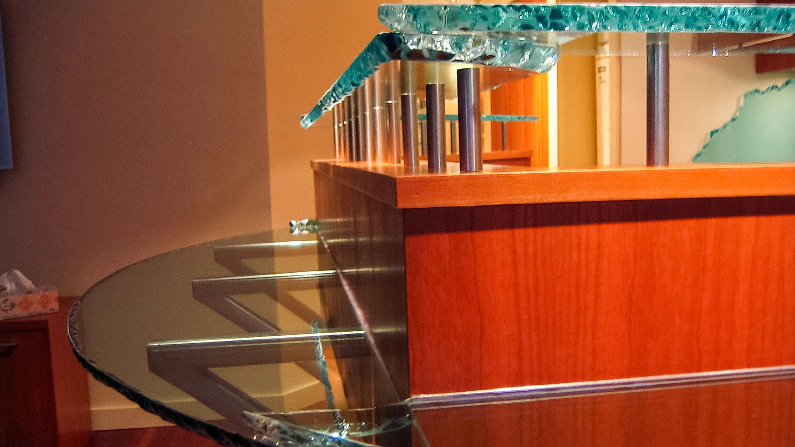 thick cast glass bar counter with textured edge raised on metal posts